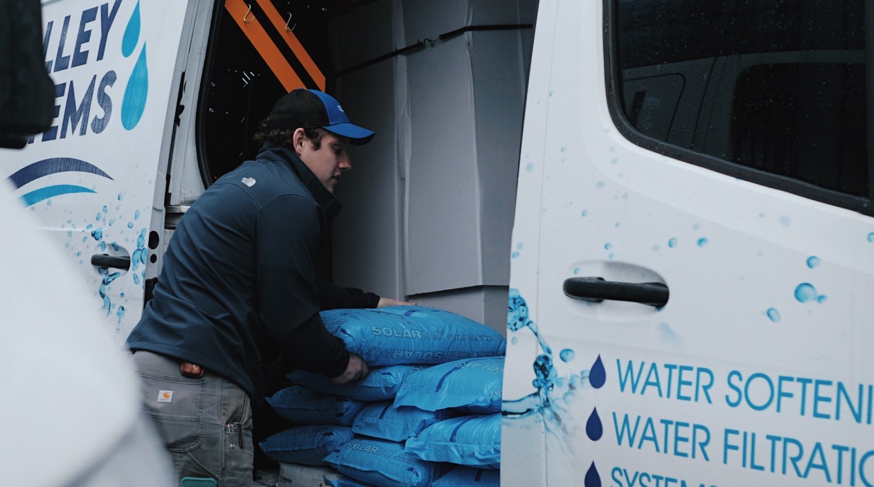man pulling bags out of van